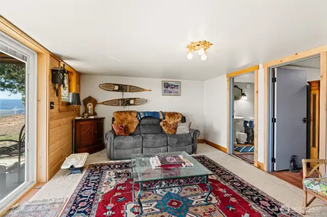 Basement suite living area with tongue and groove pine accent wall.