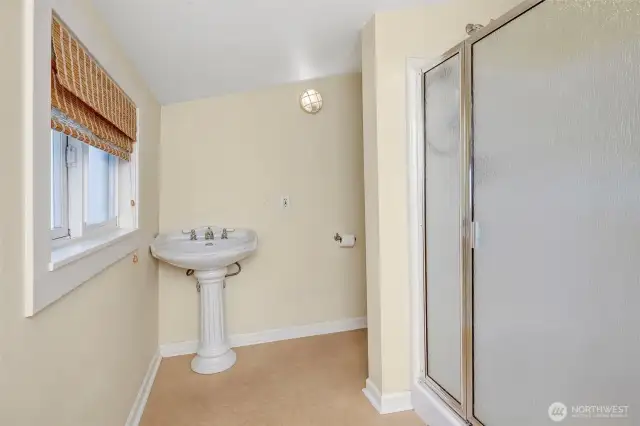 Bathroom on the main floor with a shower and the washer/dryer.