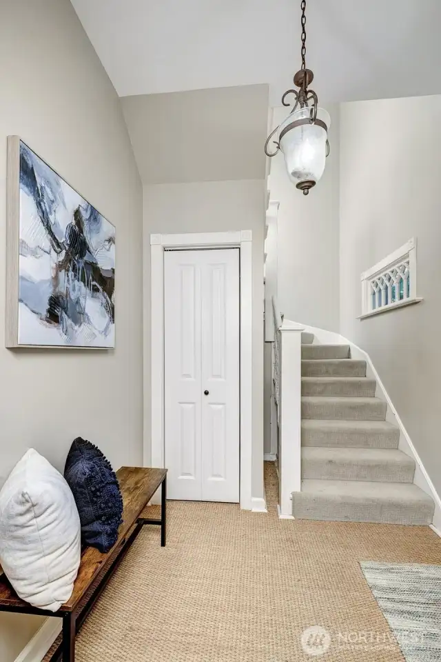 Stairway at the entry, leading to the second floor.