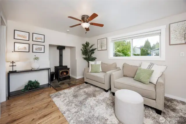 Lower level recreation room with a cozy wood burning stove & adjacent bedroom & laundry/bathroom.