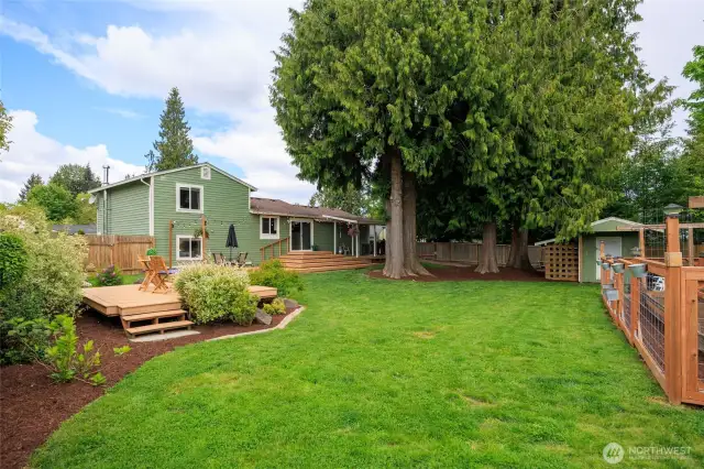 Just in time for Summer BBQ's, lawn sports, gardening & relaxation in this fully-fenced yard!