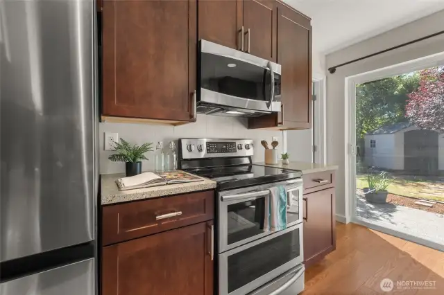 Quartz countertops and oven with optional double-oven feature and convection microwave.