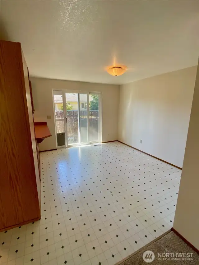 Dining area in kitchen with sliding door to patio in fully fenced back yard.