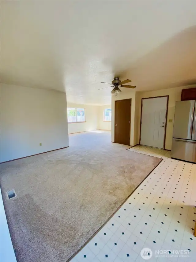 This picture shows the open concept flow design from the kitchen to the living room.