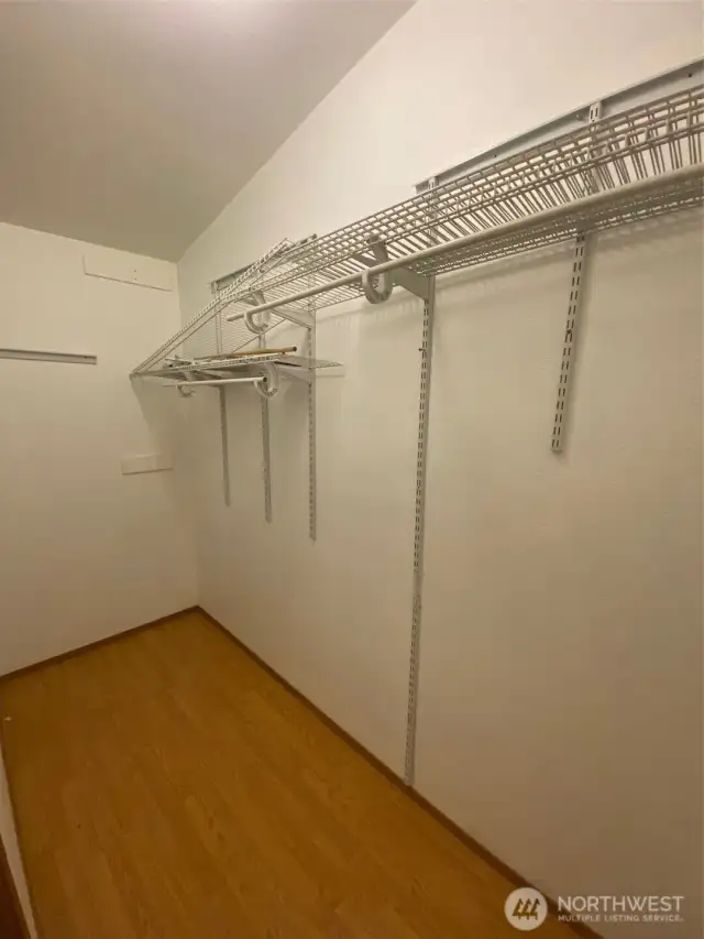 Primary walk-in closet offers lots of space for clothing.