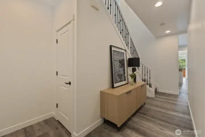 From this angle the entryway shows also the stairs going up to the 2nd floor and the rod iron balusters