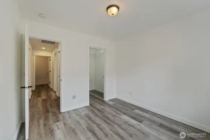 Looking into the hallway and showing the door to the walk-in closet