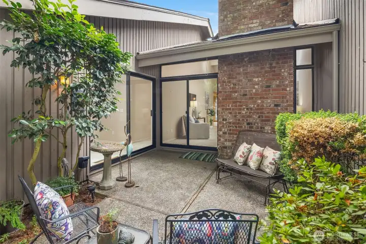 The back patio is accessible from both the primary suite and the living room.