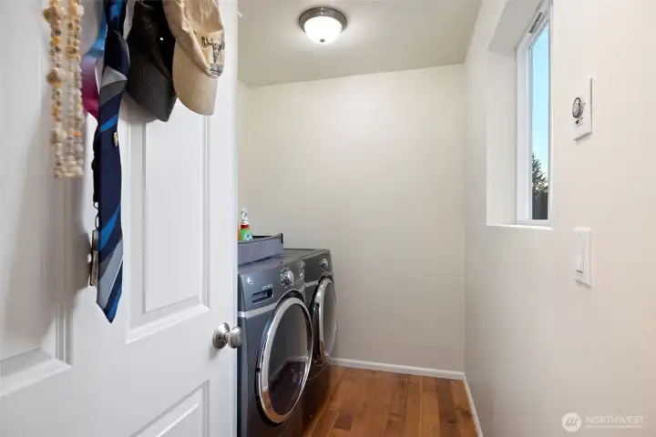 One of two laundry rooms in the home, this main-level space offers everyday practicality right where you need it. Thoughtfully designed with natural light and finished with Brazilian hardwood flooring that flows seamlessly throughout the main level, it makes day-to-day tasks effortless — a rare luxury that adds comfort and convenience to daily living.