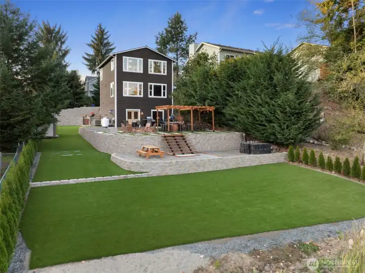 Level, low-maintenance lawn space ideal for yard games, lounging, or future garden beds — all with water views in the background.