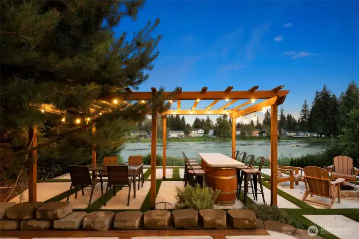 Enjoy al fresco meals under the custom pergola with café-style lighting, designed to extend your outdoor living from day into night.