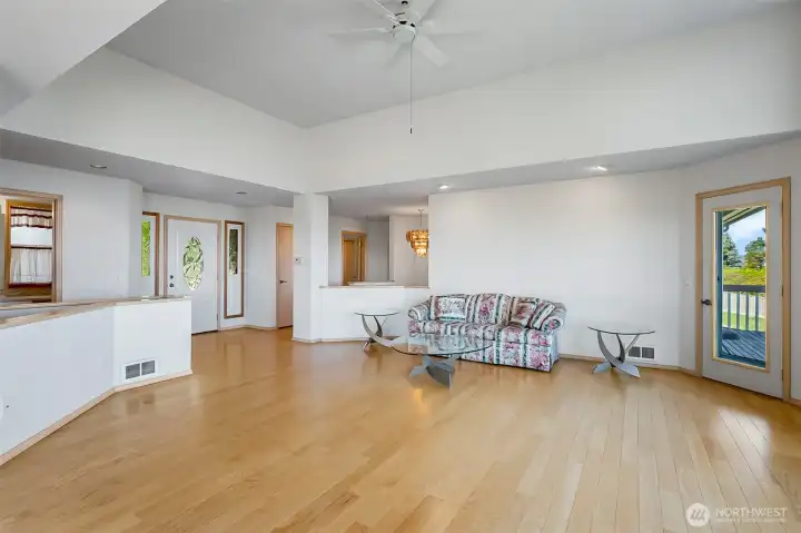 Another view of the great room pointed towards entry, and private deck to the right