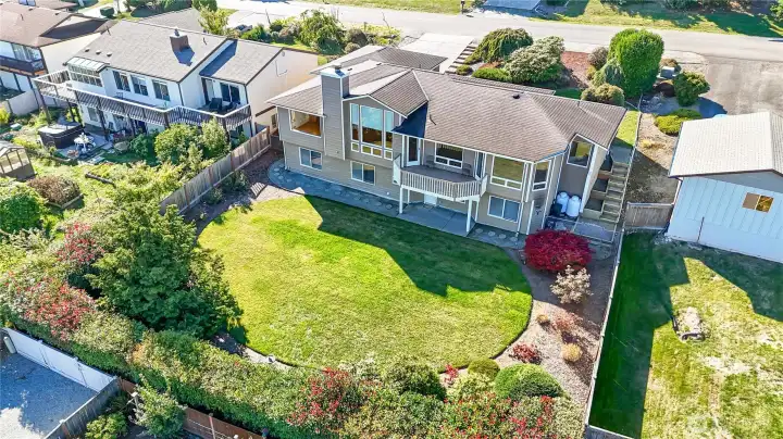 View of the landscaped back yard. Entry on either side from front.