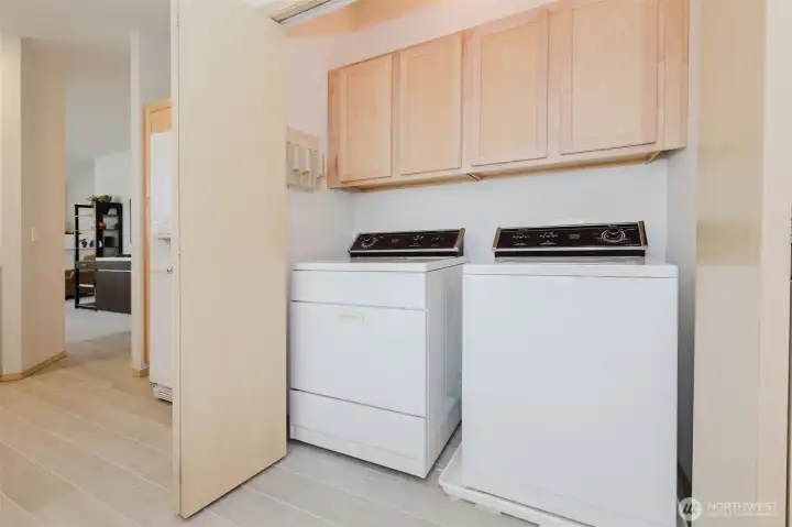Tucked away laundry with built in cabinetry.
