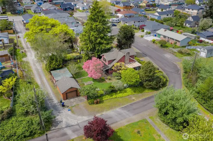 Aerial view highlights the expansive 9,000 sq ft corner lot, showcasing generous outdoor space, mature landscaping, and room to enjoy every inch of this North Tacoma property.
