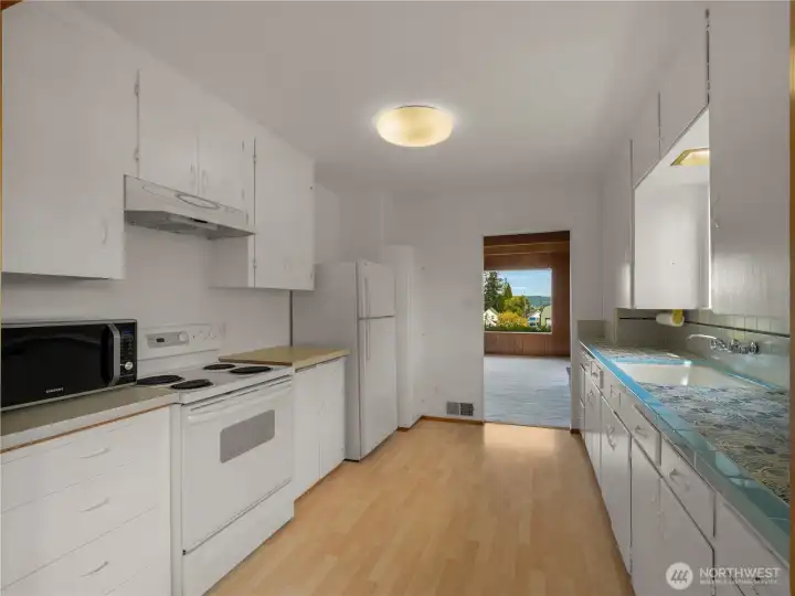 Kitchen offers abundant counter space and ample cabinetry, providing both functionality and storage in a bright, welcoming setting.