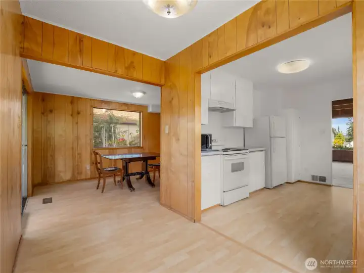 View from the kitchen showcases a charming breakfast nook and adjoining formal dining room, creating a seamless flow ideal for everyday meals and entertaining.