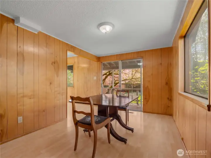 Formal dining area is filled with natural light and opens through sliding glass doors to the garden, creating an effortless indoor-outdoor connection.