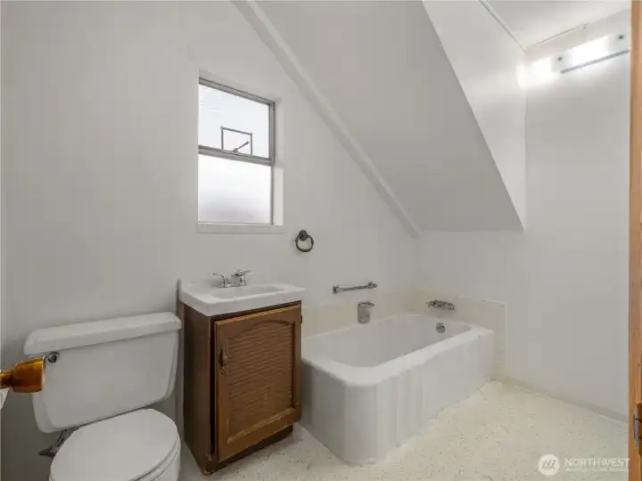 Main-level bathroom offers a functional and comfortable space with classic finishes, conveniently located for guests and everyday use.