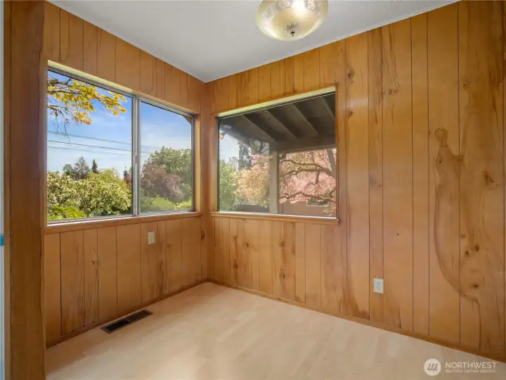 Breakfast nook off the kitchen offers a cozy, light-filled eating area perfect for casual meals with garden views just outside the window.
