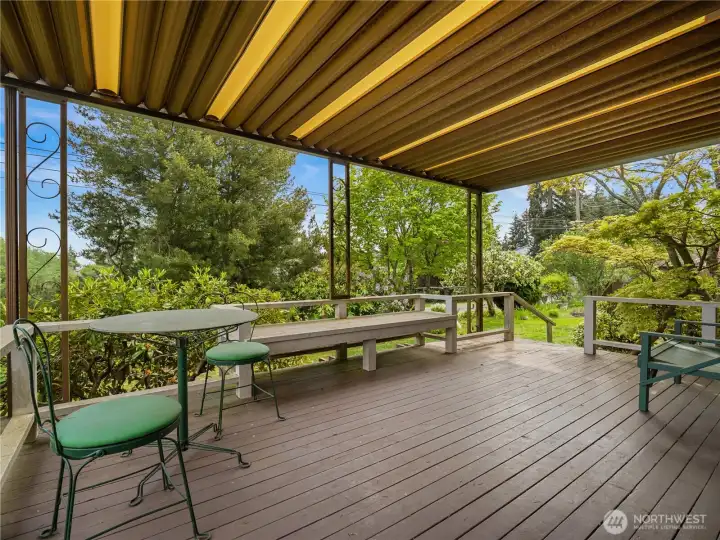 Covered outdoor area just off the sliding glass doors creates a seamless extension to the garden, offering a peaceful space for relaxing and enjoying the landscaped surroundings.