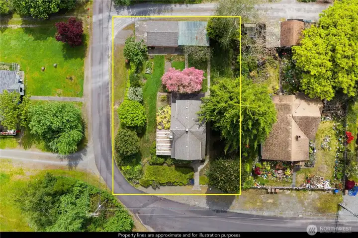 Aerial view highlights the spacious corner lot, showcasing the home’s generous grounds, mature landscaping, and prominent North Tacoma location.
