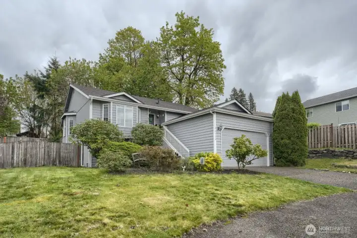 In addition to the 2 car garage, there's paved, off-street parking for 7+/- or, a boat or RV.  Nice neighborhood with sidewalks on both sides of the street- good sized front yard set off the street filled with a variety of bushes, shrubs and seasonal flowers.