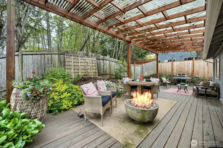 Spacious, clear cover deck.  Gas is conveniently stubbed in two areas- at the reflective rock fire pit & at the BBQ off in the distance.  Nice Trex style deck offers 3 sections. Two areas pictured here wrap around the home to a 3rd deck off the Primary bedroom which faces East for that morning sun to enjoy a cup of coffee with. Behind you is a ~40' treed buffer between you & your neighbor