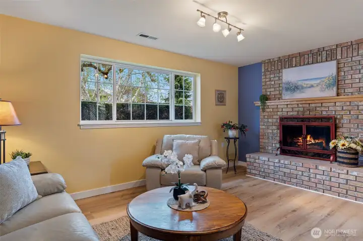 Downstairs family room has a woodburning fireplace