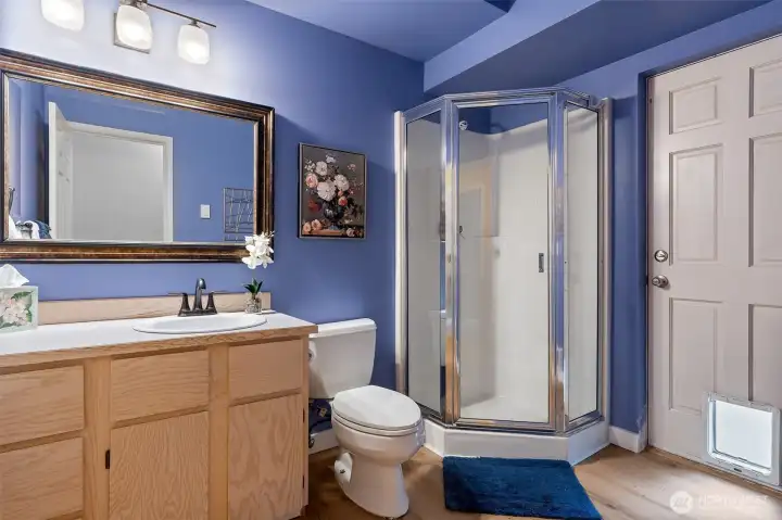 Downstairs bath with door leading to the backyard.