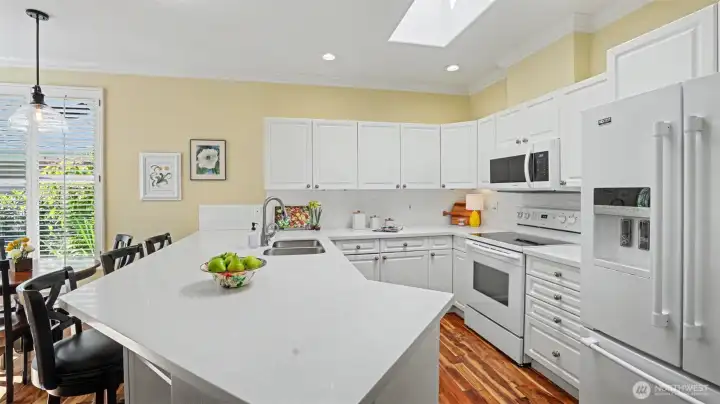 Kitchen offers sit up bar and dining area