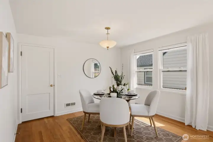 Dining room adjacent to the living room with a convenient kitchen entry through the door on the left