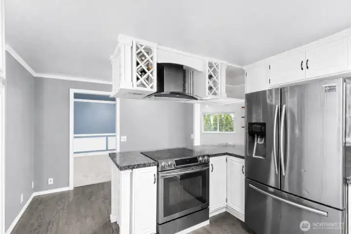 kitchen features oven, fridge, and cabinetry