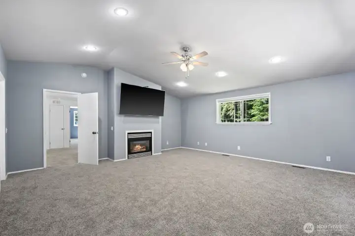 primary bedroom showcasing fireplace and window