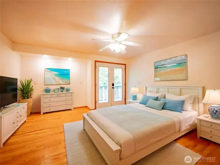 PRIMARY BEDROOM...DIGITALLY STAGED...FRENCH DOORS TO DECK