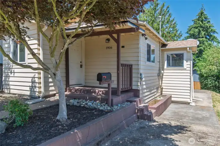 Front of home w/covered front porch, concrete driveway, w/sidewalk to back. Additional parking spot(s) to left. Front of home w/covered front porch, concrete driveway, w/sidewalk to back. Additional parking spot(s) to left.