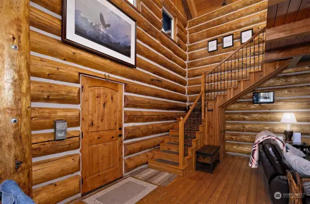 Notice the wrought iron balisters going upstairs..... oh and your "mailbox" next to the front door.  All accents that add to the extraordinary architecture of the log home.