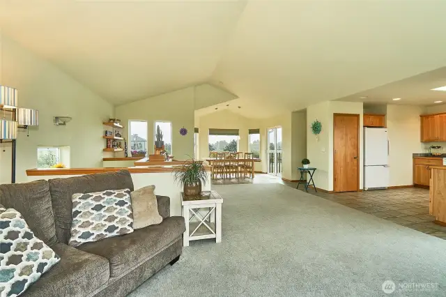 View of open concept, dining kitchen and living room, with 1/2 bath. (top floor with views)