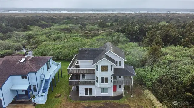 Drone shot- view of house and ocean.