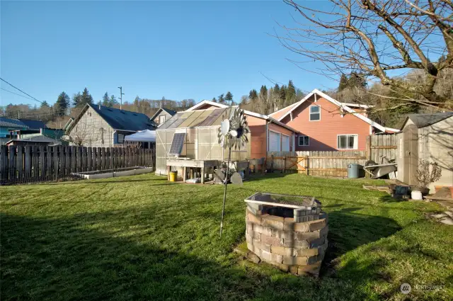 Fully fenced yard with greenhouse