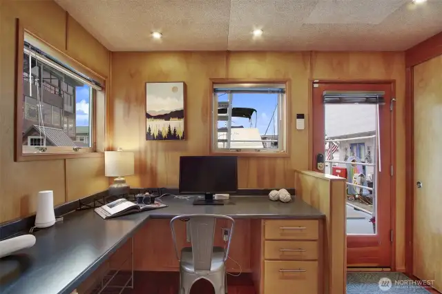 A dedicated office space in a houseboat is rare.  This built in desk with storage is quite handy to keep work separate from sleeping and lounging areas.  That is the front door and utility closets are now on your right.