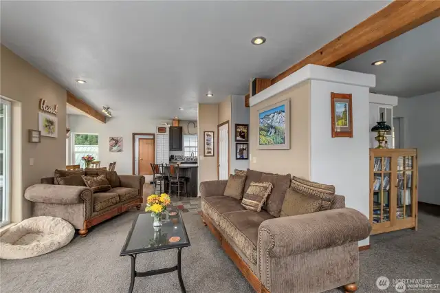 Living Room looking to kitchen and breakfast bar with entry to the right