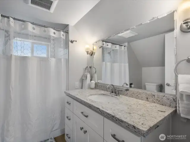 Full-height subway tile shower surround.