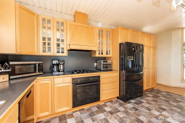 Gorgeous natural wood, custom cabinets frame the Kitchen.