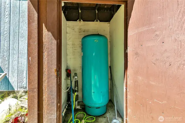 Pump house on the back side of the mobile home.