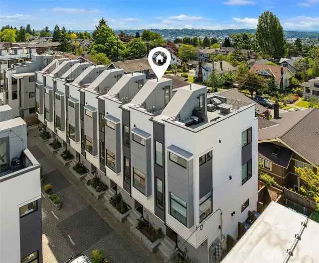 Sleek, modern townhome with private rooftop deck. Entrance to unit via quiet paver drive.