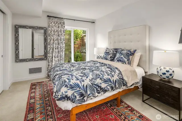 Bedroom located on first floor with sliding glass door access to back patio area.
