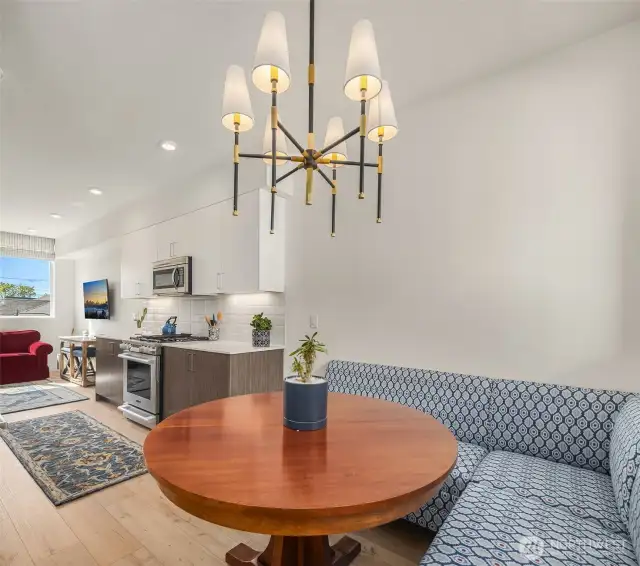 Spacious dining nook with ample seating flowing seamlessly into kitchen.