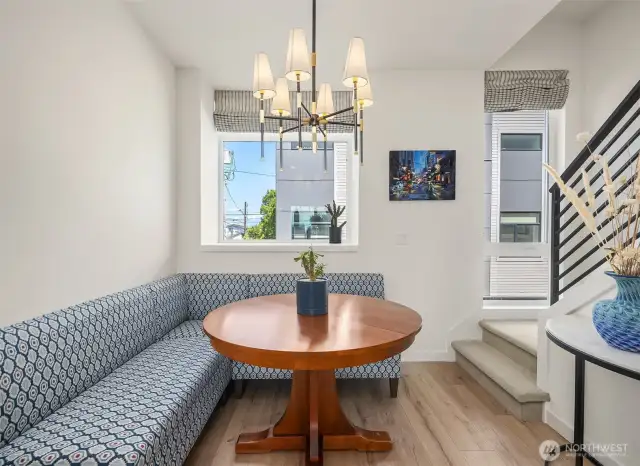 Elegant dining nook with large window and bench seating.