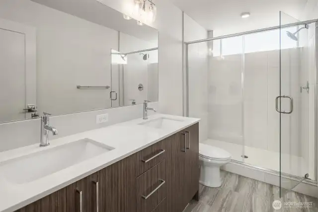 En-suite bathroom equipped with double sinks and ample counter/storage space.